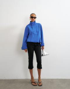 Model wearing Denim funnel neck bubble hem top in colbalt