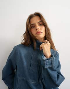 Model wearing Denim funnel neck bubble hem top in sulphur blue