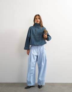 Model wearing Denim funnel neck bubble hem top in sulphur blue