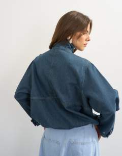 Model wearing Denim funnel neck bubble hem top in sulphur blue