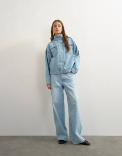 Model wearing Denim funnel neck elastic hem detail jacket in bleach