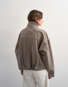 Model wearing Denim funnel neck elastic hem detail jacket stone