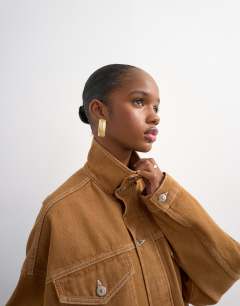 Model wearing Denim funnel neck elastic hem detail jacket tobacco