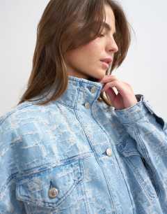 Model wearing Denim funnel neck elastic hem detail jacket ultra-distressed bleach