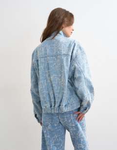 Model wearing Denim funnel neck elastic hem detail jacket ultra-distressed bleach