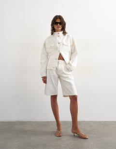 Model wearing Denim funnel neck elastic waist jacket in distressed ecru