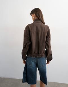 Model wearing Denim funnel neck jacket with waist detail in chocolate