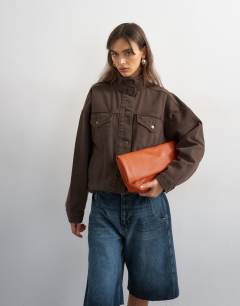 Model wearing Denim funnel neck jacket with waist detail in chocolate