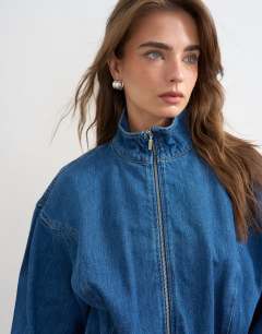 Model wearing Denim funnel neck mini dress in mid blue