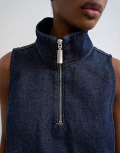 Model wearing Denim funnel neck pinny dress blue rinse