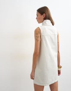 Model wearing Denim funnel neck pinny dress in bone