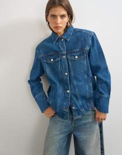 Model wearing Denim jacket with strong shoulder in mid blue