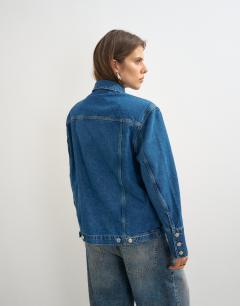 Model wearing Denim jacket with strong shoulder in mid blue