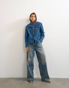 Model wearing Denim jacket with strong shoulder in mid blue