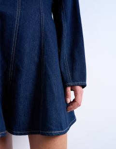 Model wearing Denim long sleeve flared mini dress in rinse