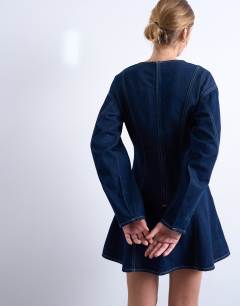 Model wearing Denim long sleeve flared mini dress in rinse