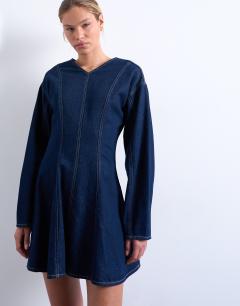 Model wearing Denim long sleeve flared mini dress in rinse