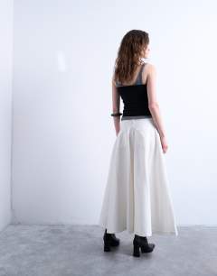 Model wearing Denim maxi full circle skirt in ecru