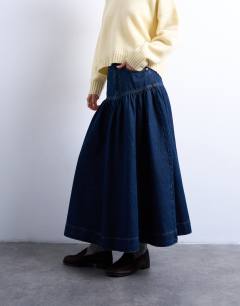 Model wearing Denim maxi skirt with gathered yoke detail in rich blue