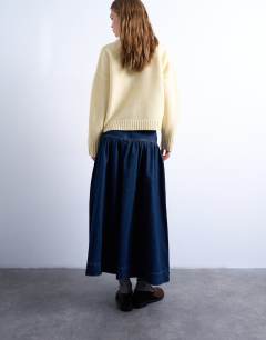 Model wearing Denim maxi skirt with gathered yoke detail in rich blue