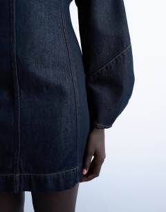 Model wearing Denim mini dress with ovoid sleeve in indigo