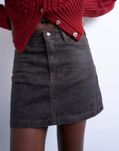 Model wearing Denim mini pelmet skirt in brown crackle
