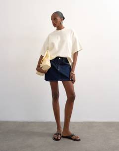 Model wearing Denim mini pelmet skirt in indigo rinse