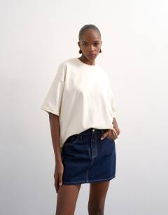 Model wearing Denim mini pelmet skirt in indigo rinse