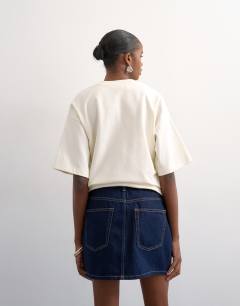 Model wearing Denim mini pelmet skirt in indigo rinse