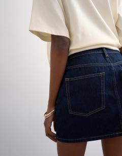 Model wearing Denim mini pelmet skirt in indigo rinse