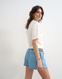 Model wearing Denim mini runner short in mid blue