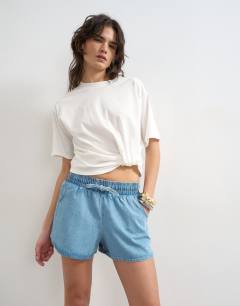Model wearing Denim mini runner short in mid blue