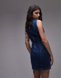 Model wearing Denim mini shift dress in mid blue