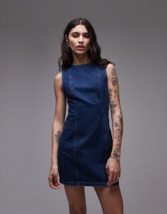Model wearing Denim mini shift dress in mid blue