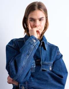Model wearing Denim oversized dad jacket with belt tie in indigo
