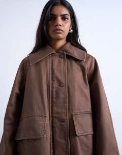 Model wearing Denim oversized waxed jacket in brown