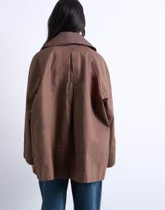 Model wearing Denim oversized waxed jacket in brown