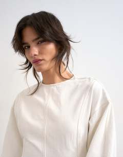 Model wearing Denim ovoid sleeve mini dress bone