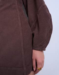 Model wearing Denim ovoid sleeve mini dress in otter cord