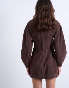 Model wearing Denim ovoid sleeve mini dress in otter cord