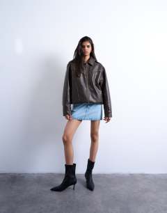 Model wearing Denim pelmet mini skirt in bleach