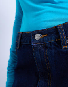 Model wearing Denim pelmet mini skirt in raw look indigo