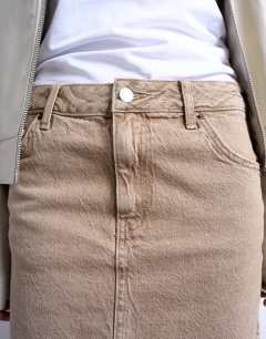 Model wearing Denim pelmet mini skirt in washed beige