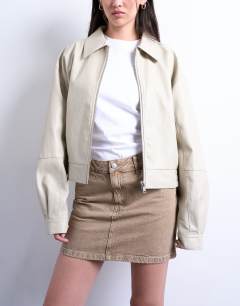 Model wearing Denim pelmet mini skirt in washed beige