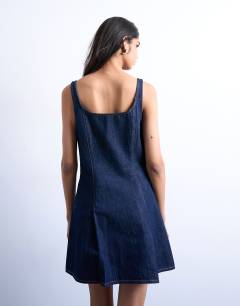 Model wearing Denim pleat detail mini dress in indigo rinse
