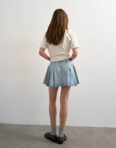 Model wearing Denim pleated full mini skirt in bleach