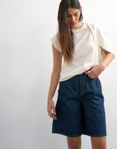 Model wearing Denim pleated longline short in indigo rinse