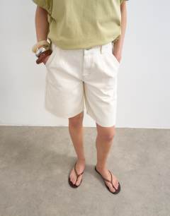 Model wearing Denim pleated longline short in white