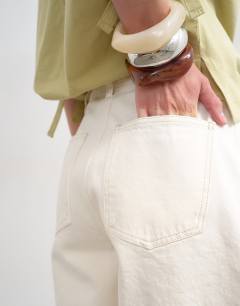 Model wearing Denim pleated longline short in white