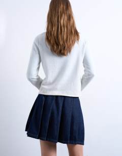 Model wearing Denim pleated wrap mini skirt in indigo